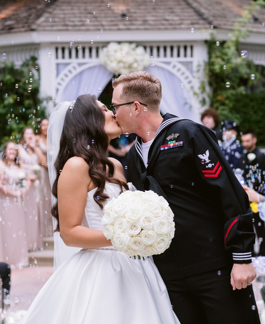 Bride and groom kissing after their outdoor wedding ceremony
